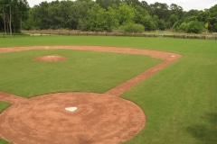 Wide angle view from home plate to the outfield of a baseball and softball diamond.